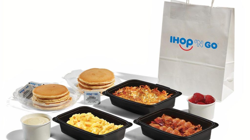 Close-up of a smartphone screen showing IHOP menu prices on a delivery app.