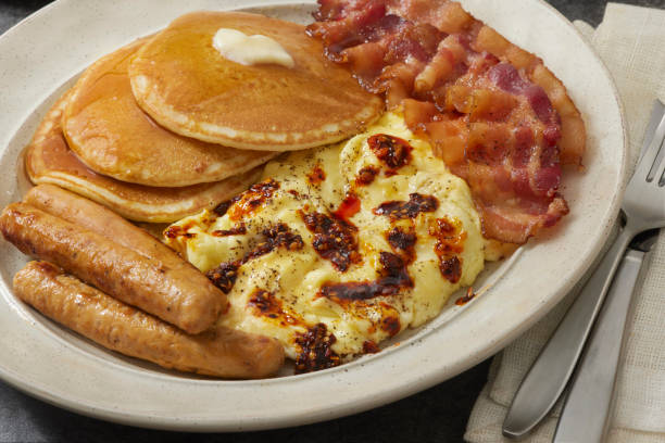 IHOP breakfast spread with pancakes, omelette, and bacon